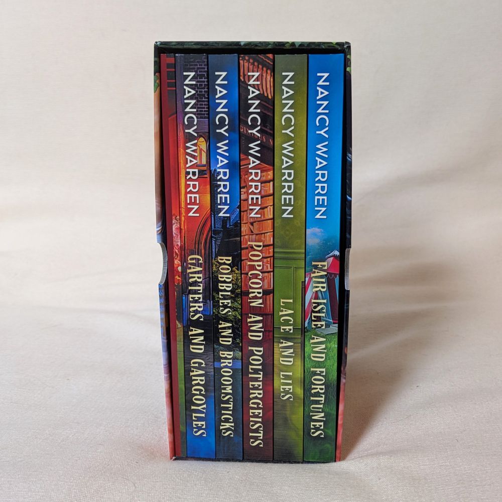 Stack of books by Nancy Warren on a light gray background