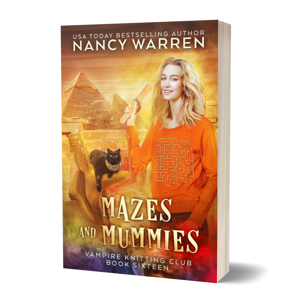 The paperback cover of Mazes and Mummies by Nancy Warren. A blonde woman holds an ancient papyrus in front of a background of Egyptian monuments. A black cat sits on a statue.
